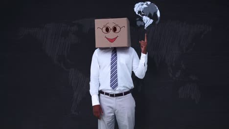 businessman wearing smiley face box pointing on globe