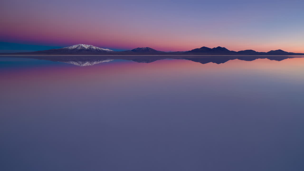 Reflective Mountain Sunset over a Calm Lake