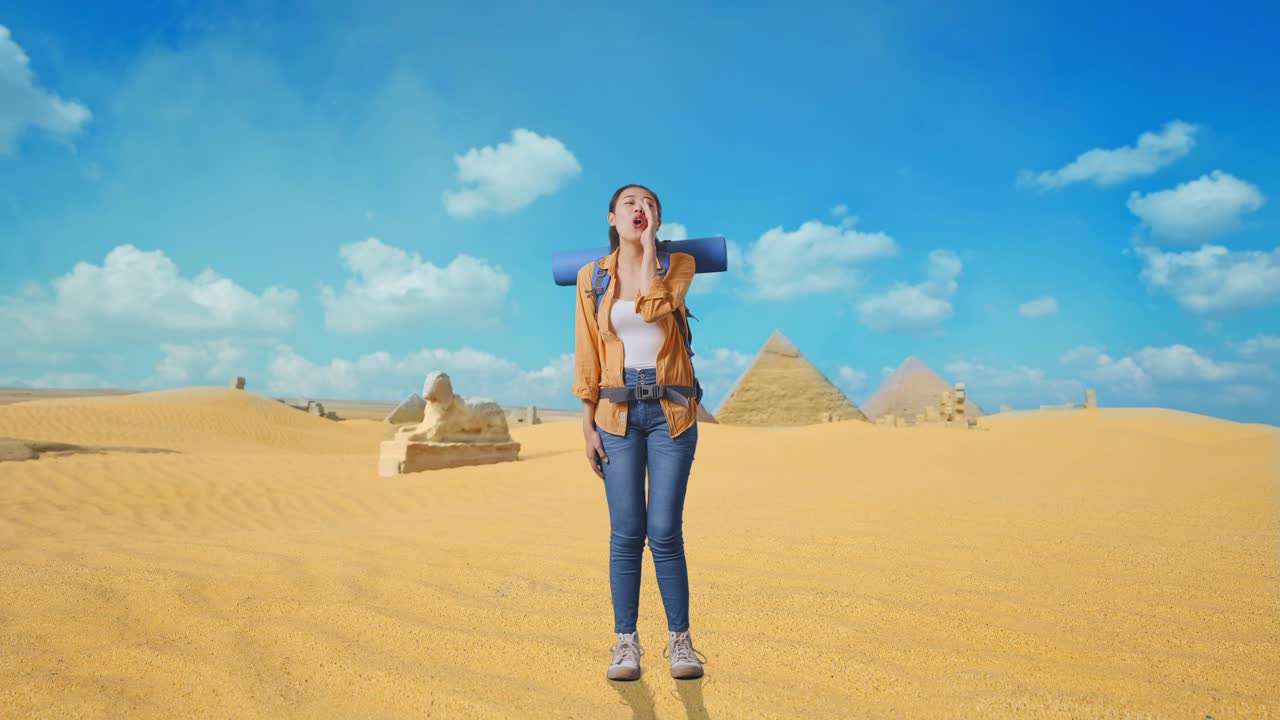 Full Body Of Asian Female Hiker With Mountaineering Backpack Screaming Holding Hands Near Her Mouth While Traveling In Pyramid Of Giza