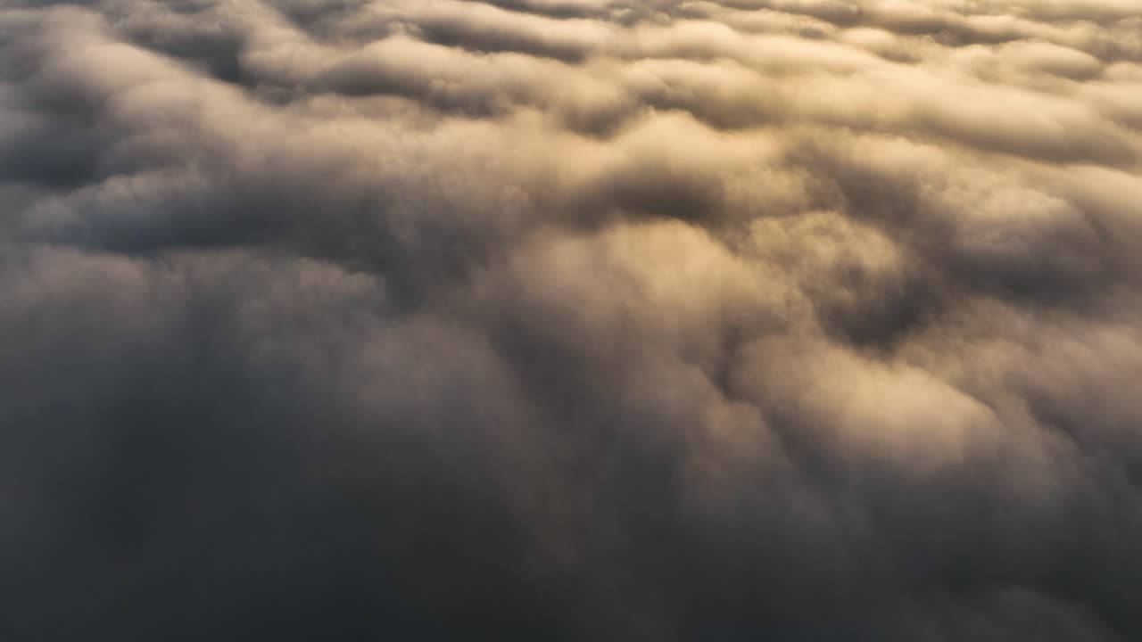 Cinematic Aerial Drone Shot Flying High above the Clouds at Sunset