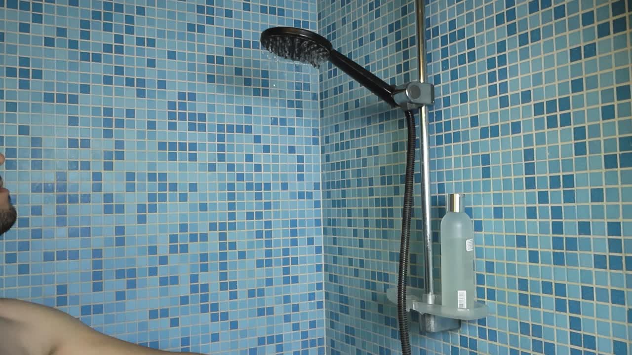 hombre lavando el cabello en la ducha