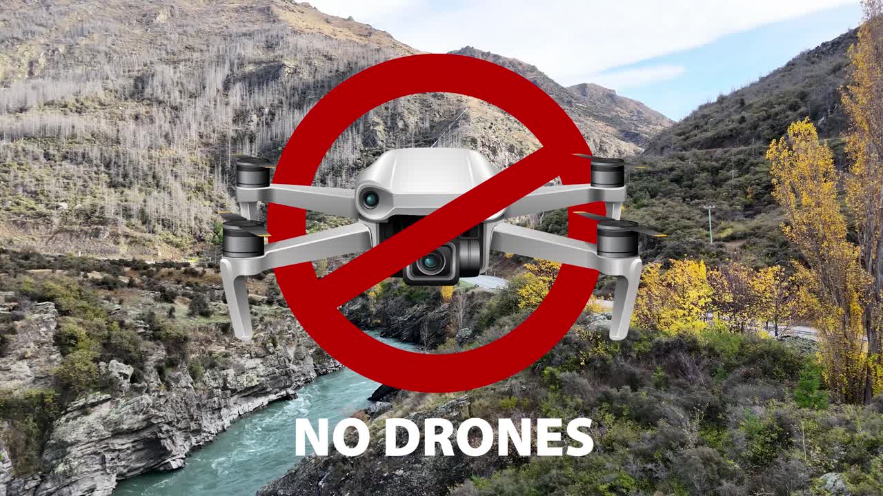Animation highlights drone ban over a picturesque New Zealand canyon with vibrant autumn foliage and a flowing river