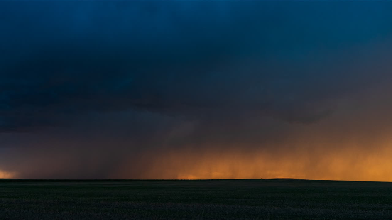 Dramatic storm with lightning over a field at night