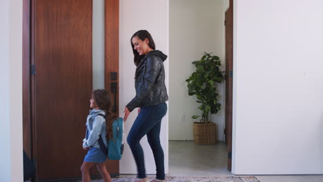 Parents-And-Daughter-With-Luggage-Opening-Door-And-Leaving-Home-For-Vacation