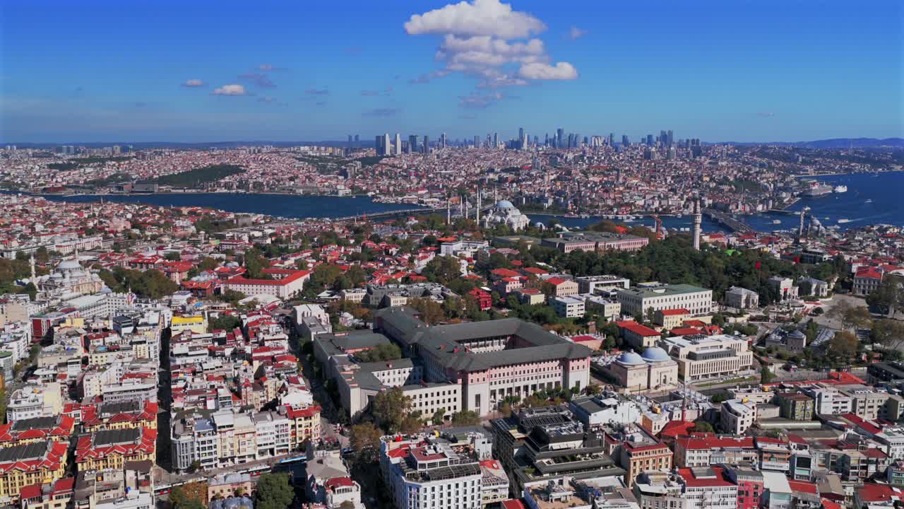 Morning Fatih Istanbul Turkey Türkiye aerial drone cityscape harbor view Golden Horn Blue Mosque temple Hagia Sophia Grand Mosque blue sky clouds Bosphorus Strait river ferries forward pan up motion