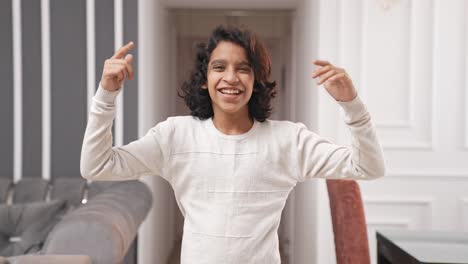 Energetic-Indian-teenager-kid-boy-celebrating-and-enjoying