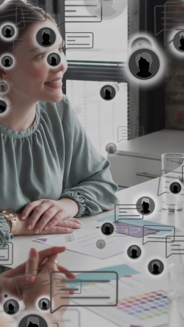Vertical video: On cue woman at table tracking speaker, checking colors, icons crossing for design