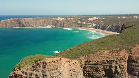 Aerial:-The-town-of-Arrifana-with-people-surfing