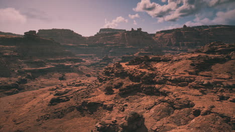 vast desert landscape with rugged rock formations under a cloudy sky