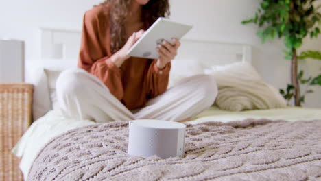 Close-up-view-of-smart-speaker-on-the-bed