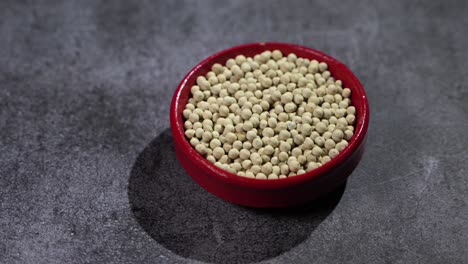 white pepper is placed on a bowl