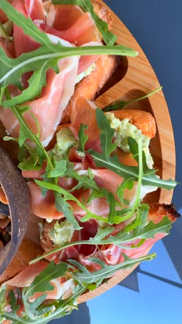 prosciutto and avocado bruschetta with mixed nuts