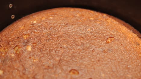 freshly baked cake in a round baking pan