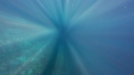 sunrays under the deep blue sea. - underwater