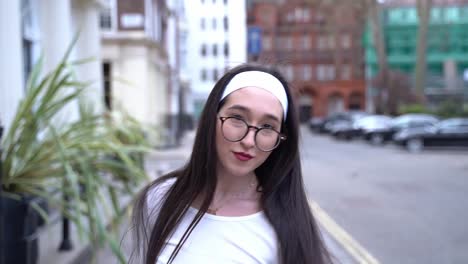 Following-a-woman,-she-turns,-hair-flips,-Soho,-London,-close-up-slow-motion