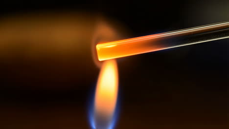 heating a glass tube with a flame