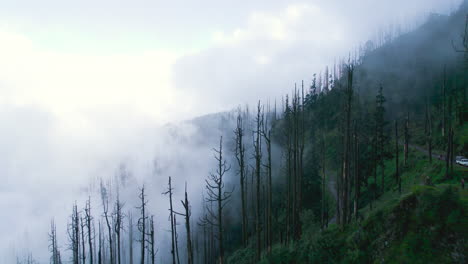 fpv drone shot of nepal landscape with clouds, monsoon season, gloomy mood horror cinematography