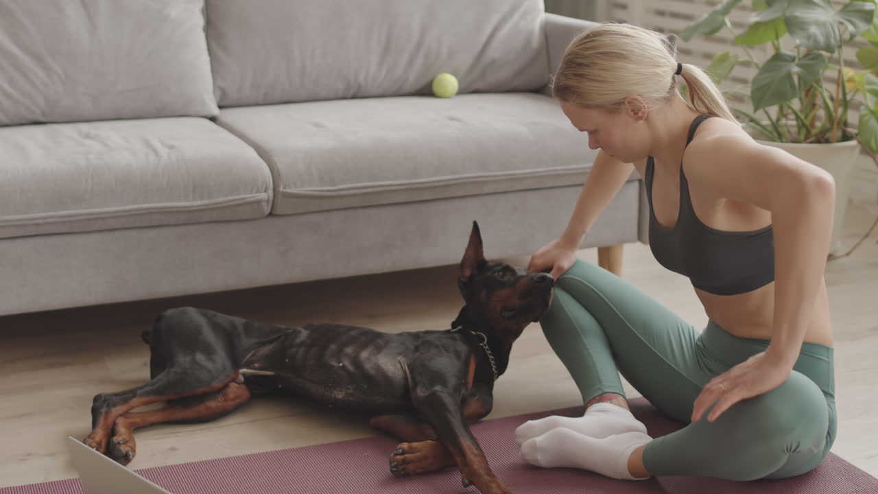 Sporty Female Dog Owner at Home