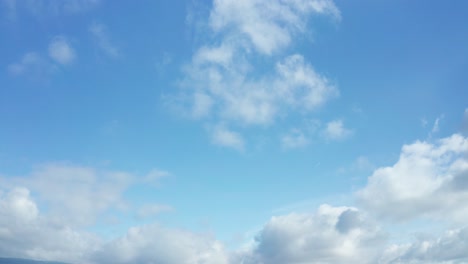 blue skies and white puffy clouds dance across the slow skies