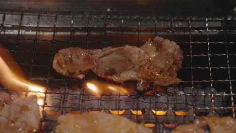 pork sizzles while on the flaming griller
