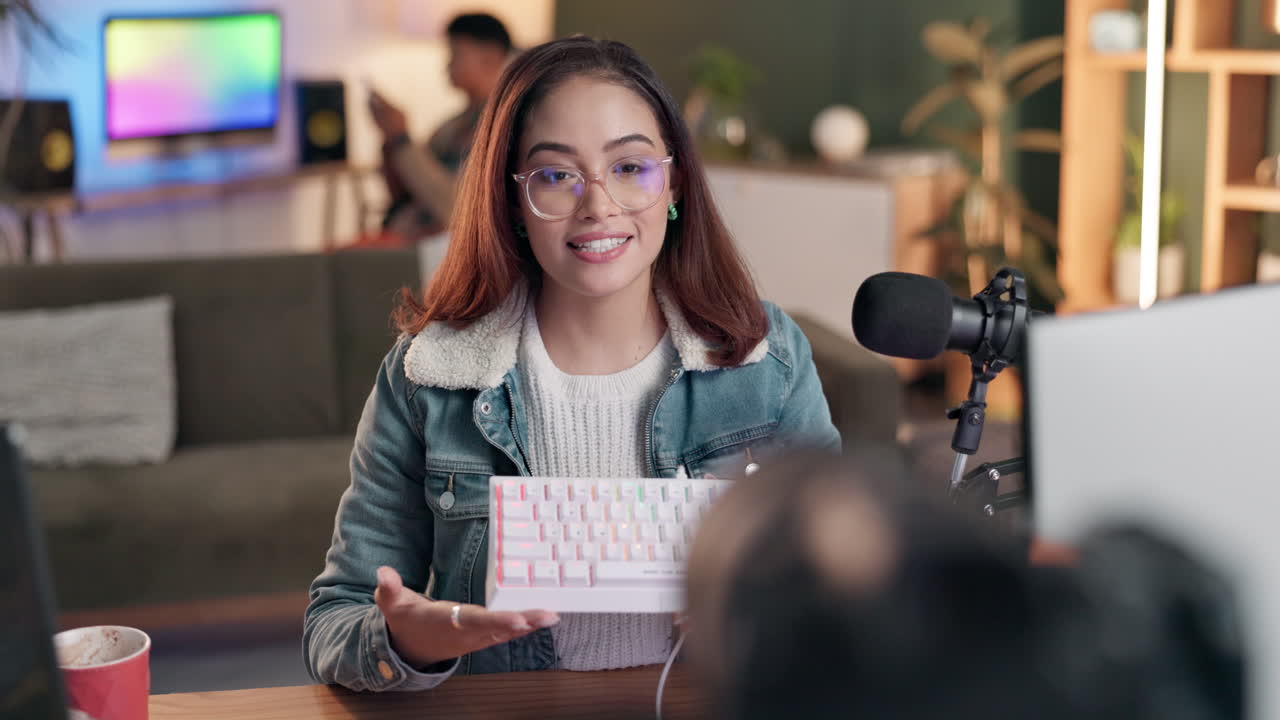 Woman showing off keyboard on podcast
