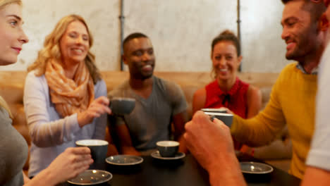 Group-of-happy-friends-interacting-while-having-coffee-4K-4k