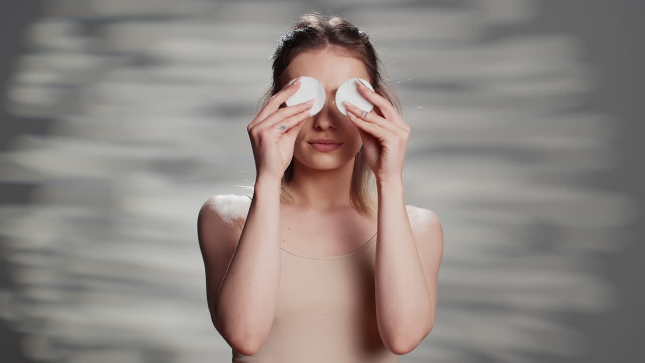 Woman using cotton pads for skincare