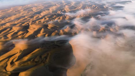 aerial view titing over endless, namib desert dunes, foggy morning in namibia