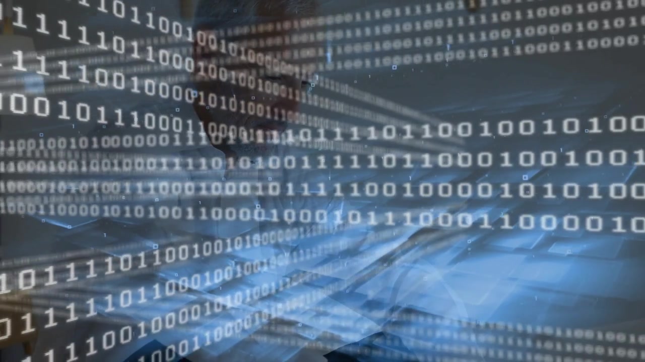 Mature man typing at desk, initiating streaming binary overlay and analyzing data on monitor