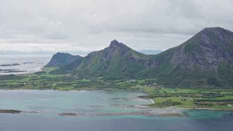 Picturesque-Lush-Mountainscape-With-Calm-Ocean-In-The-Islands-Of-Norway