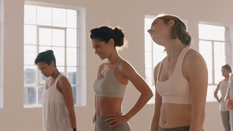 happy multi racial women in yoga class stretching preparing for workout practice enjoying healthy physical lifestyle ready to train at sunrise