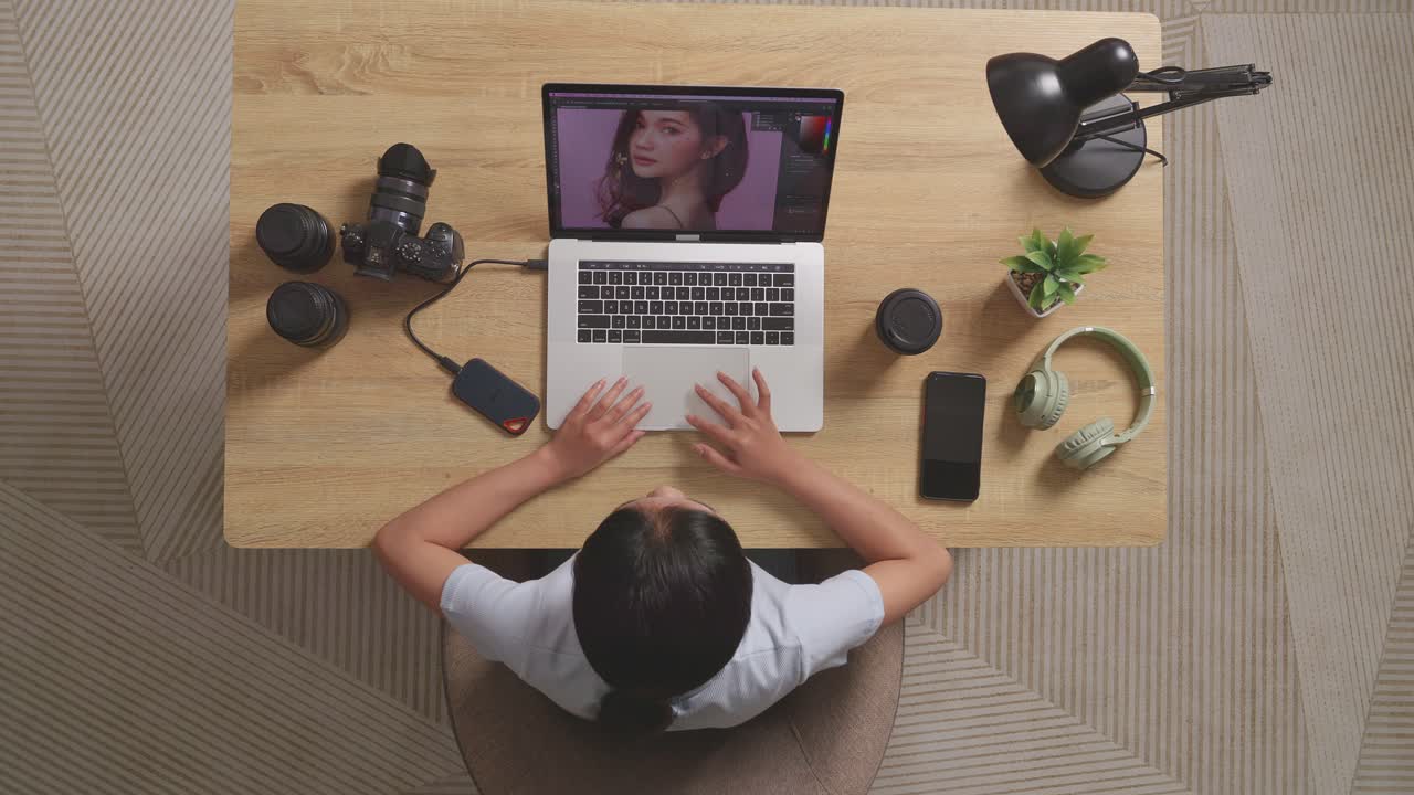 Top View Of A Woman Editor Celebrating Succeed Using A Laptop Next To The Camera Editing Photo Of A Woman In The Workspace At Home