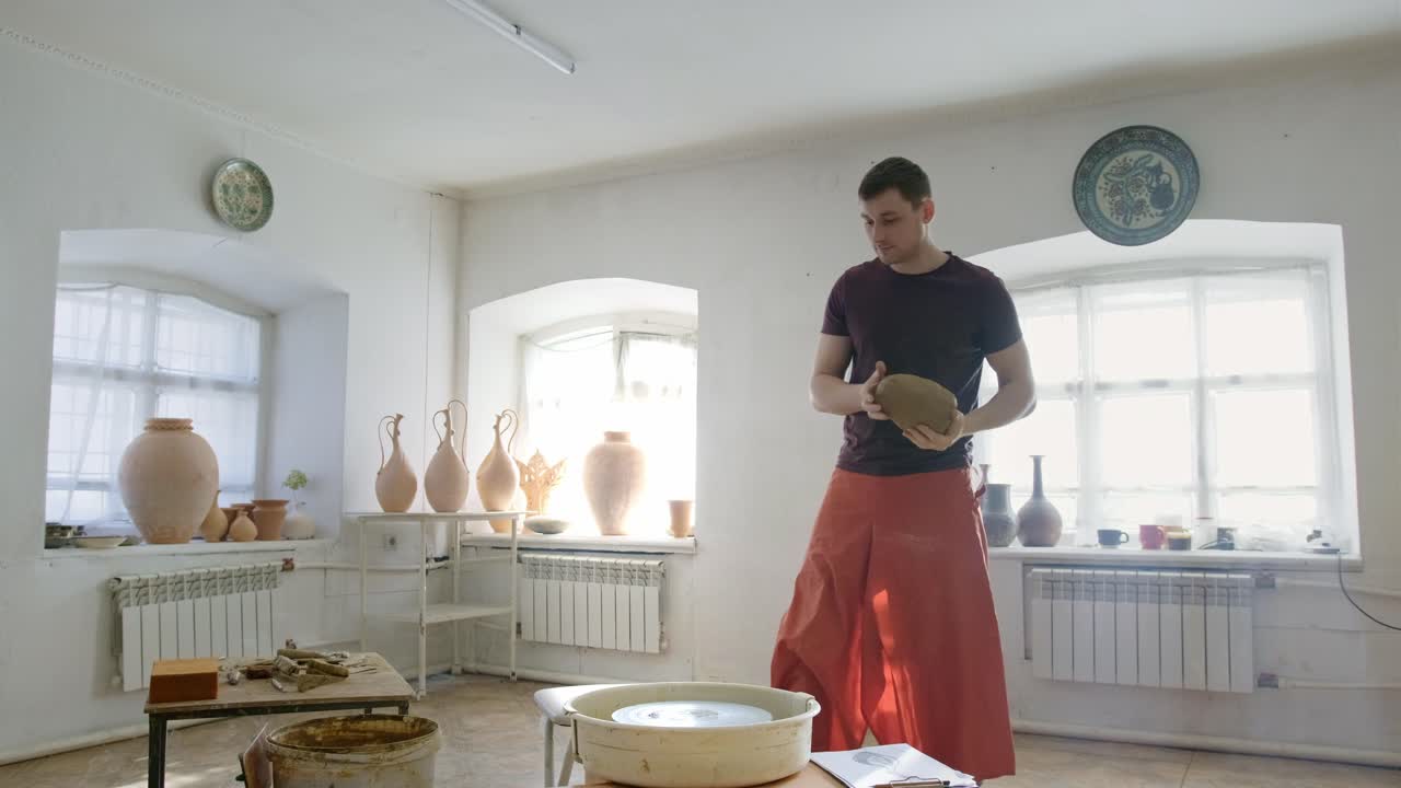 Pottery Artist Shaping Clay on Wheel