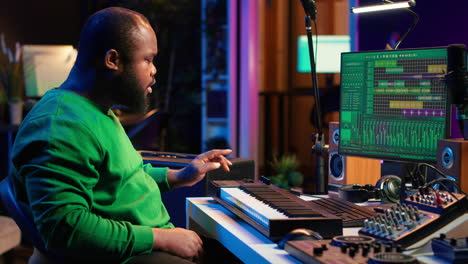 Sound engineer recording piano notes with DAW software in his home studio