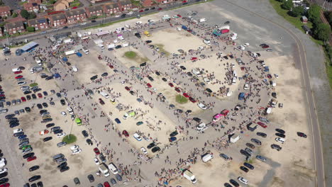 floating high aerial drone shot towards a busy market and car boot sale in hull england uk