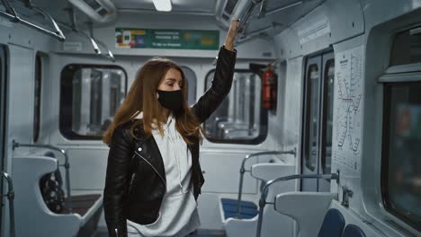 coronavirus lockdown. young lady travelling in subway, standing alone in empty carriage, studying map