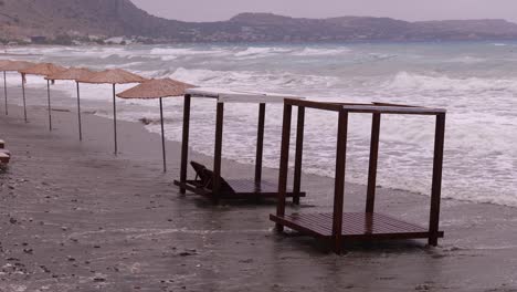 Parasols-And-Sunshades-Hit-By-Stormy-Waves-At-The-Mediterranean-Sea