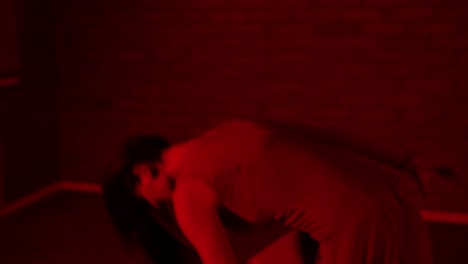 professional female dancer expressing herself in a red room