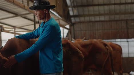 asian man farmer showing his healthy cow and smiling in organic cow farm