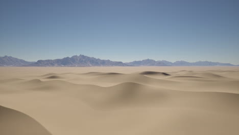 arid landscape with sand dunes and mountain range