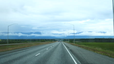 Cars-Pass-by-on-Open-Highway-in-Alaska