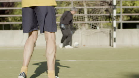 elderly man scoring goal, falling to knees and celebrating with his team