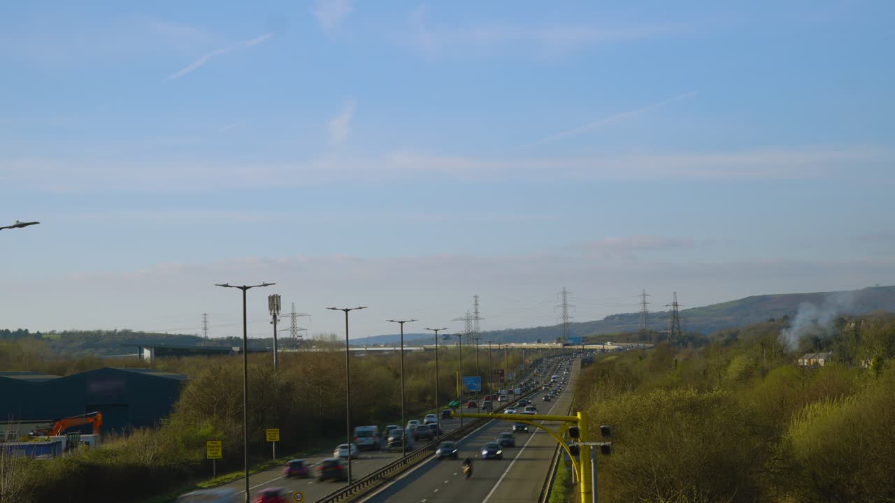 Fast Moving Traffic Timelapse of Cars and Trucks Travelling Along M4 Motorway Road in Wales with Motion Blur. Transport Highway Time Lapse Footage.