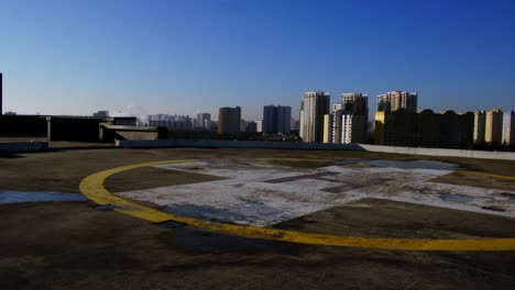 view of the helipad on the roof of a building in the city.