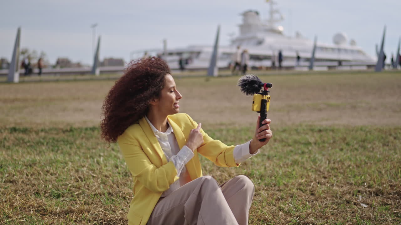 Woman taking a selfie near a bicycle and a ship