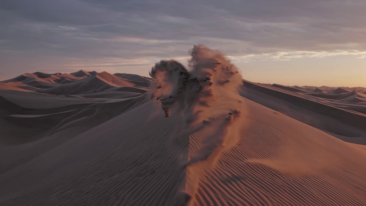 Aerial view of vast desert dunes at sunset, capturing the serene beauty and shadows