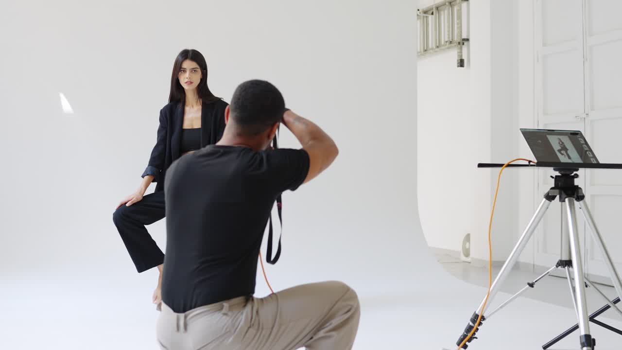 Fashion photoshoot in a studio with a photographer and a model