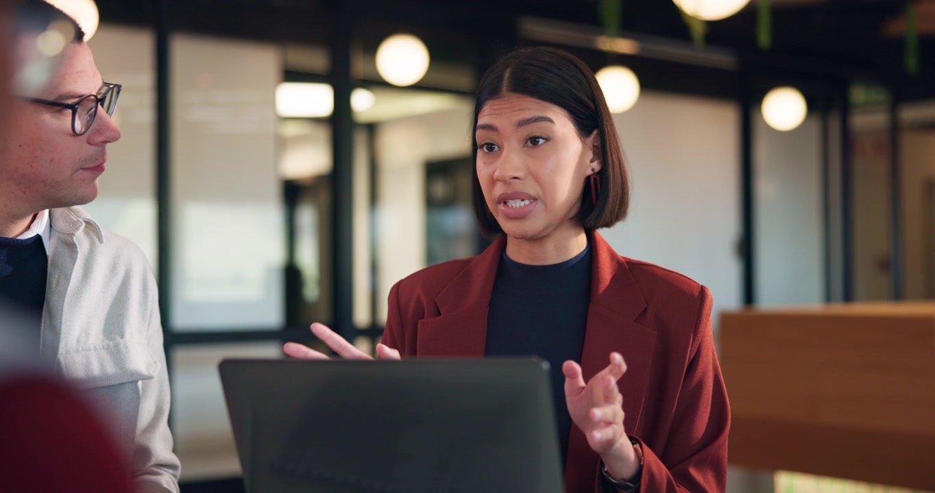 Professional Woman Discussing Work with Colleague in Modern Office