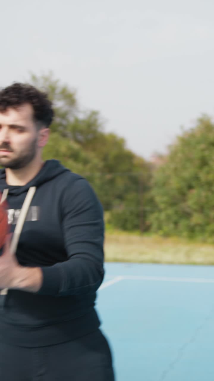 Basketball Player Does Tricks With the Ball Spinning at the Park Court