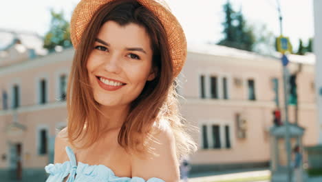 woman wearing a straw hat in a city